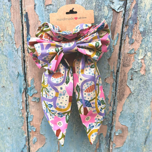 Colorful bow-shaped hair accessory on a rustic wooden background